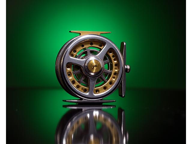 Restored vintage fishing reel gleaming, looking brand new.